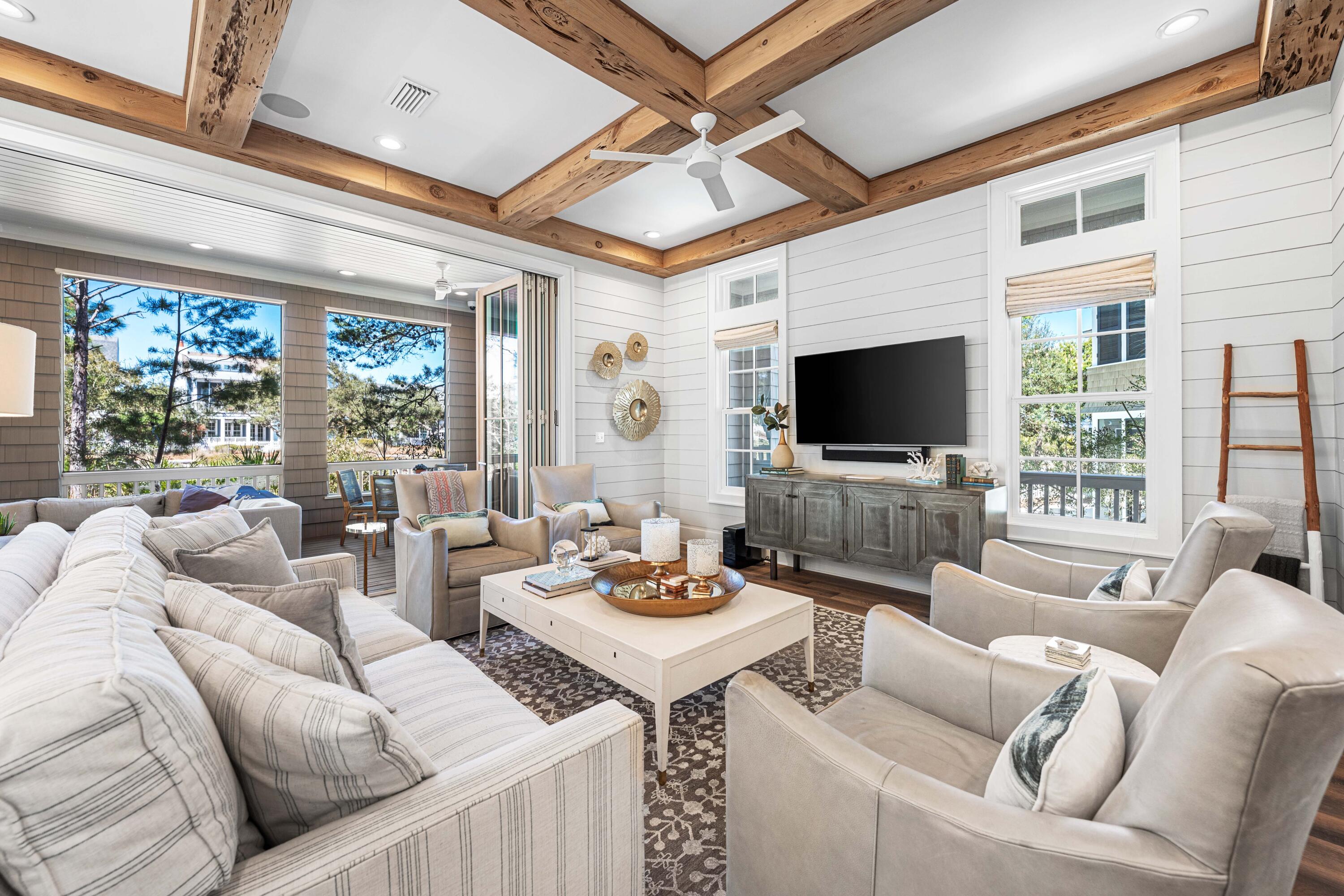 41 Compass Point Way Watersound, FL 32461 - Photo 2 of 75 a living room with furniture a flat screen tv and a floor to ceiling window