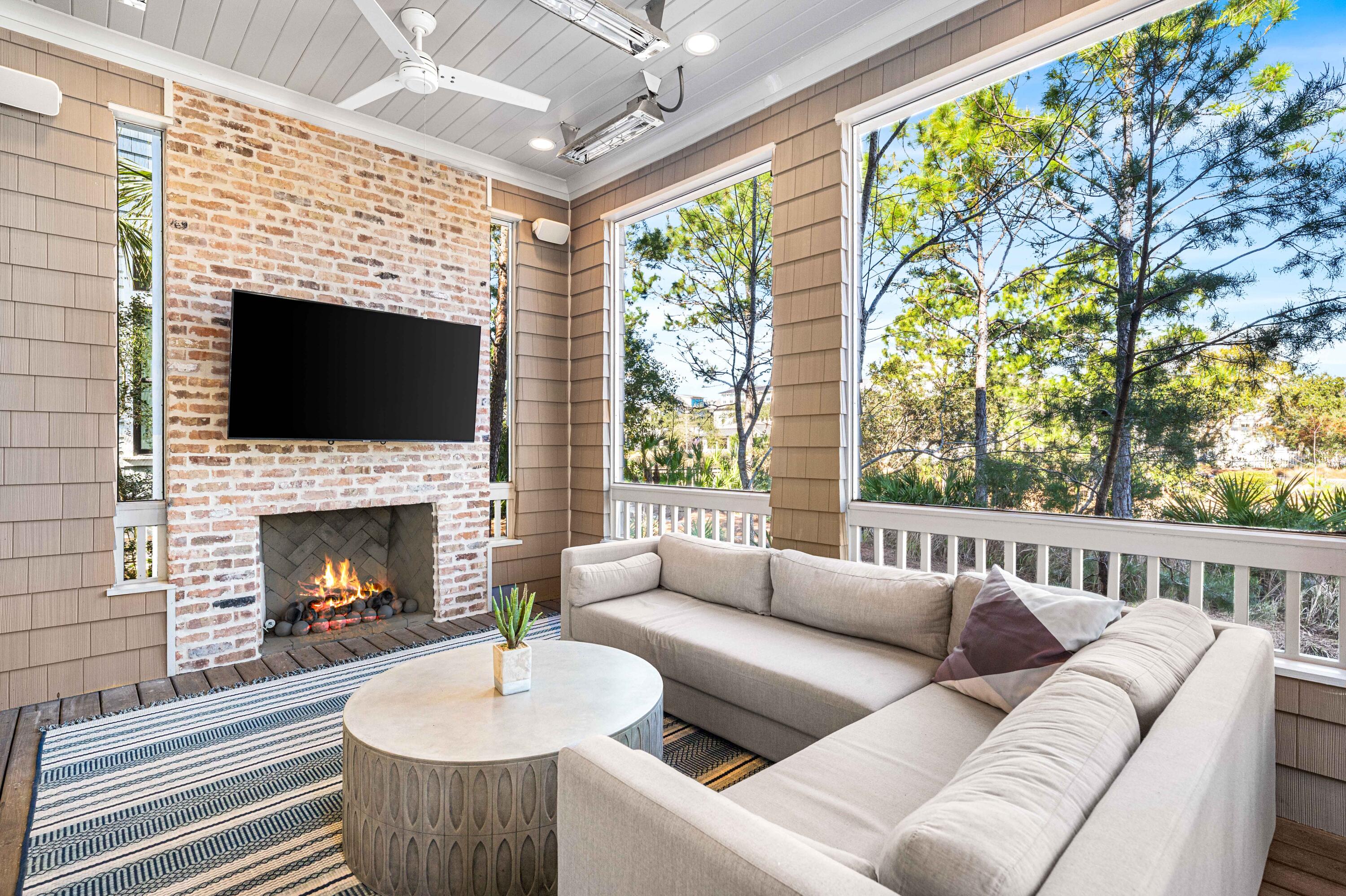 41 Compass Point Way Watersound, FL 32461 - Photo 3 of 75 a living room with furniture a fireplace and a large window