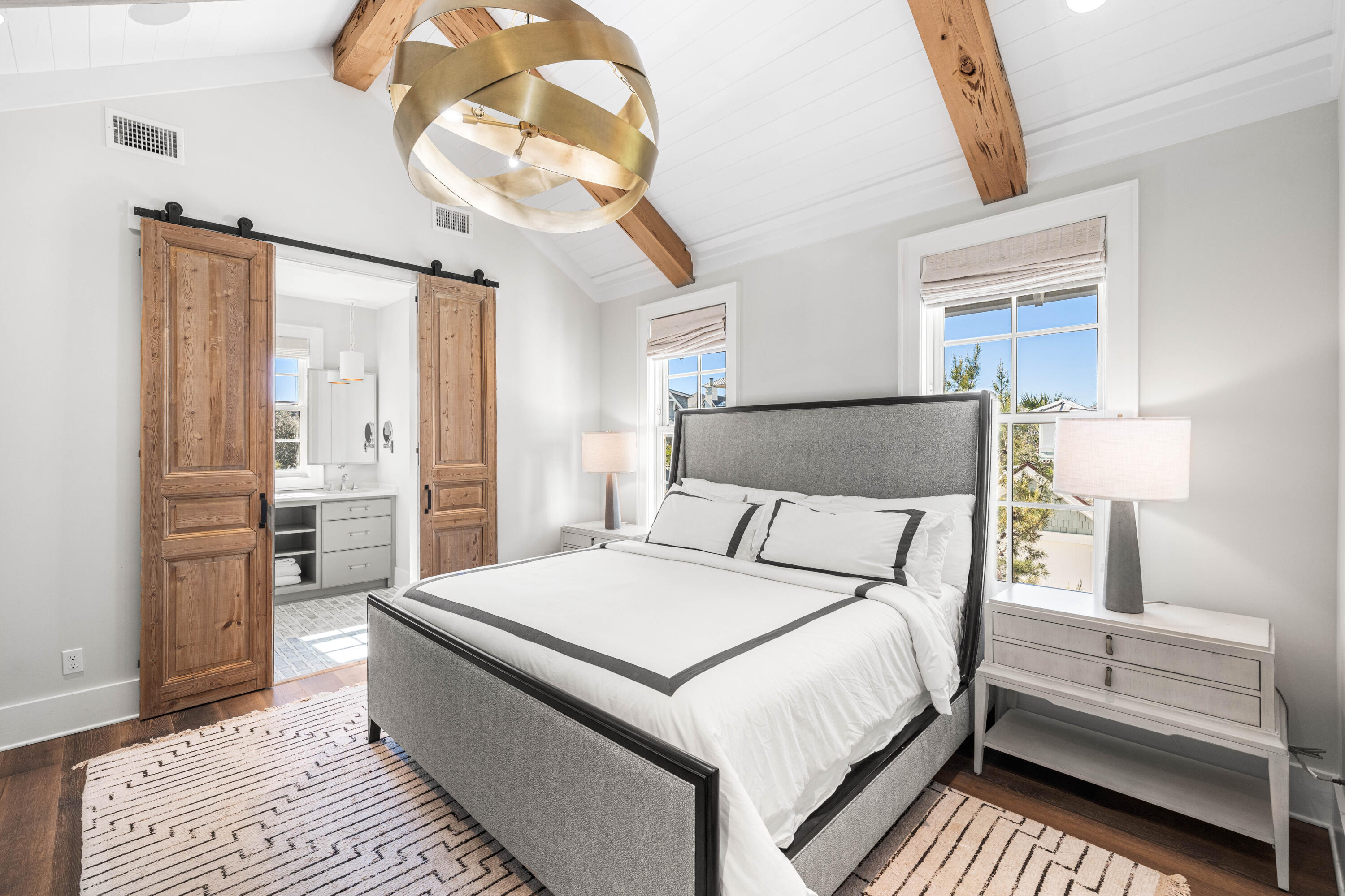 41 Compass Point Way Watersound, FL 32461 - Photo 36 of 75 a bedroom with a large bed and a chandelier