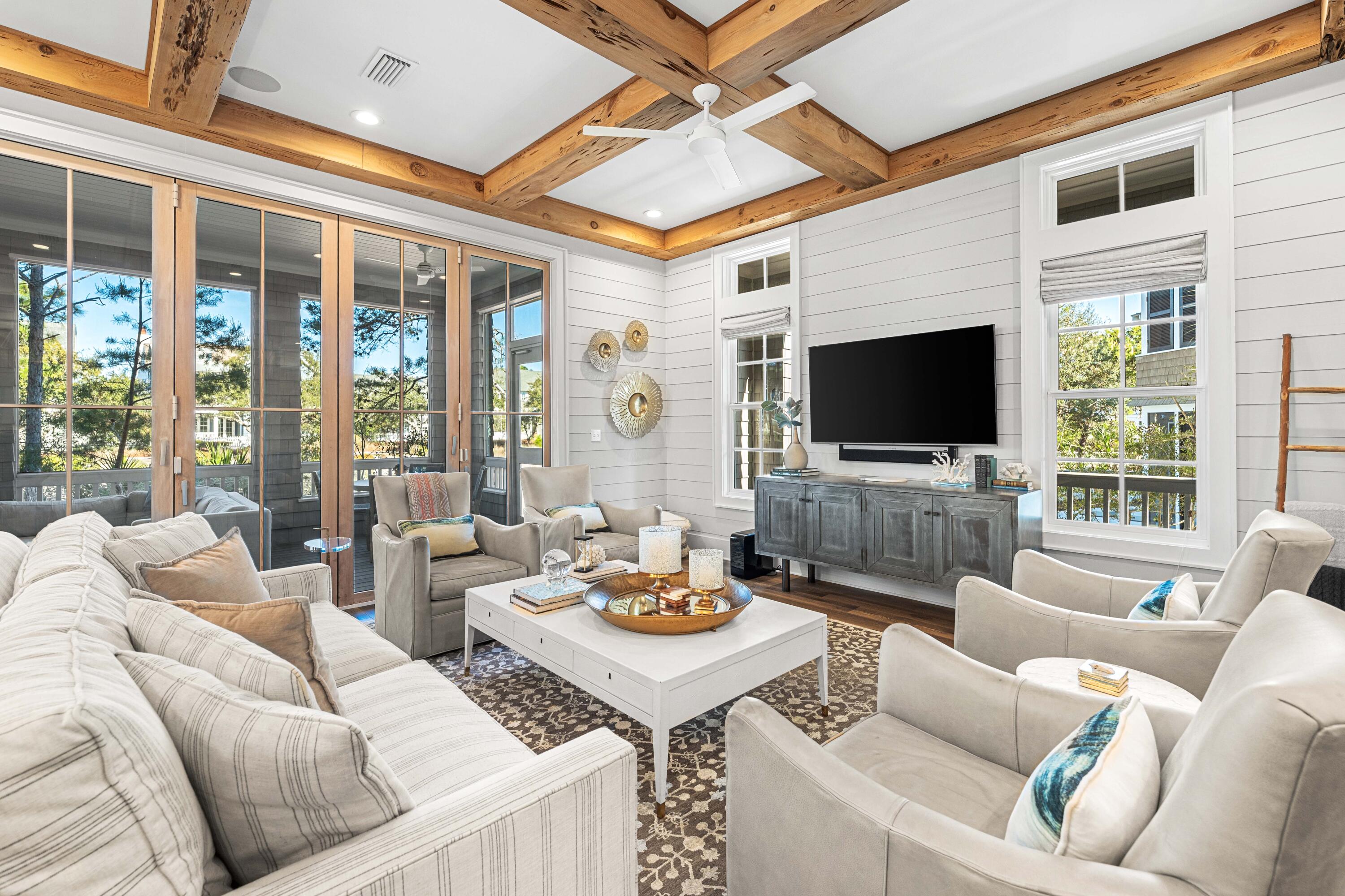 41 Compass Point Way Watersound, FL 32461 - Photo 5 of 75 a living room with furniture a flat screen tv and a floor to ceiling window