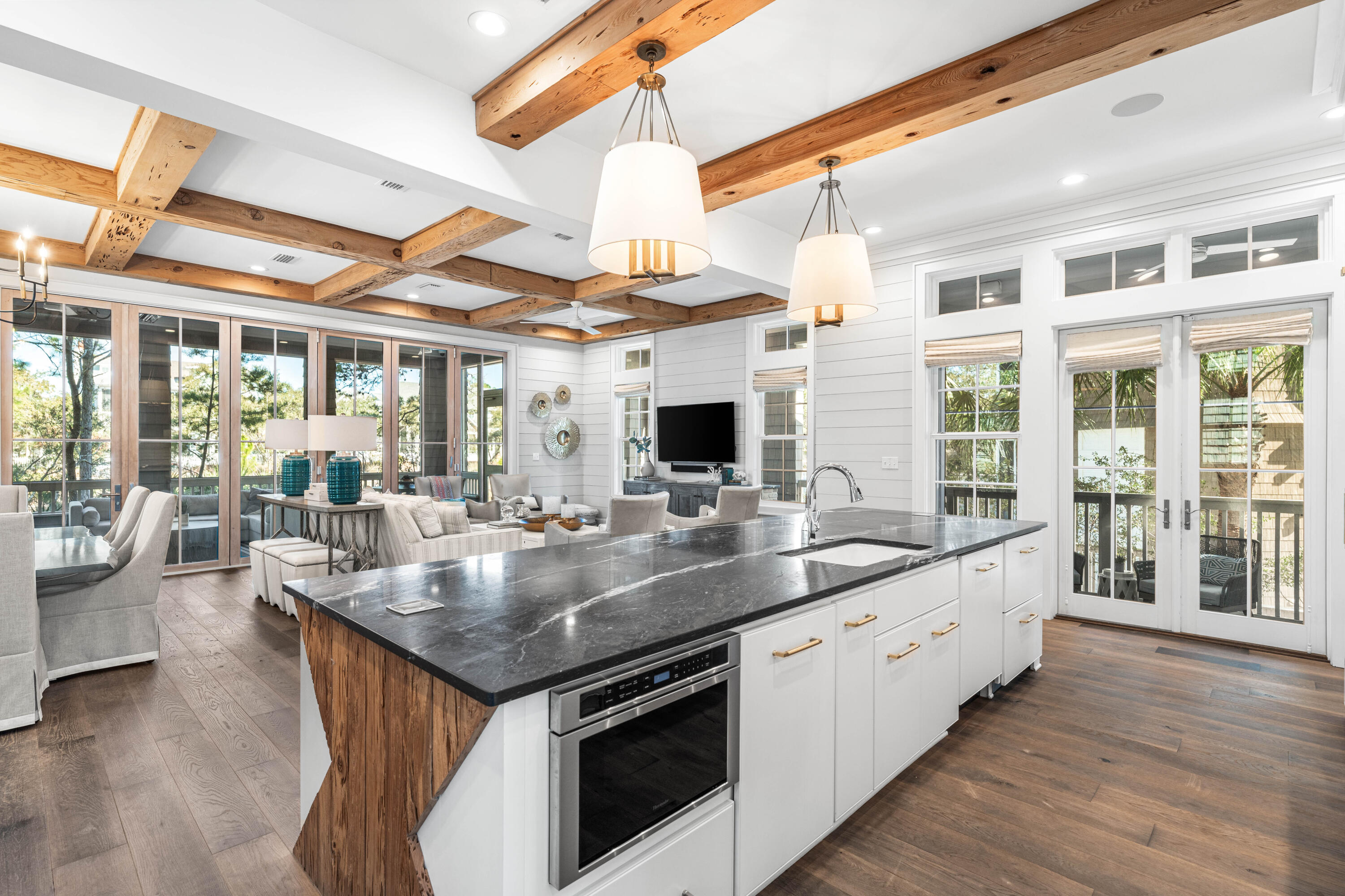 41 Compass Point Way Watersound, FL 32461 - Photo 10 of 75 a kitchen with stainless steel appliances granite countertop a sink and wooden floor