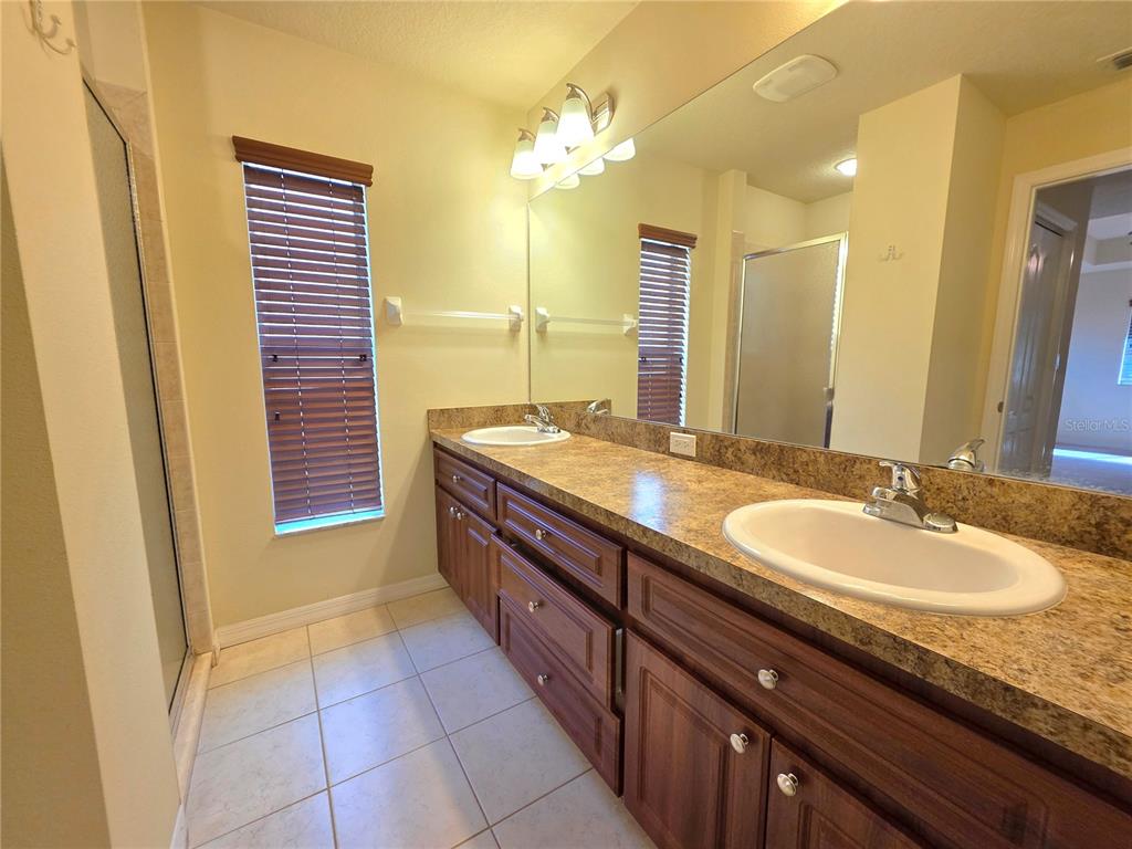 4284 High Ridge Avenue Spring Hill, FL 34609 - Photo 25 of 40 a bathroom with a granite countertop sink and a mirror