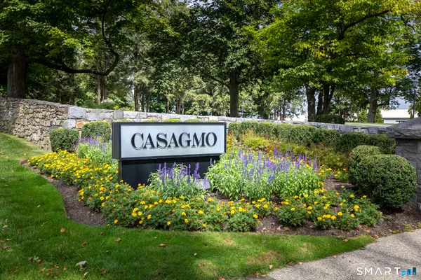 a sign broad in front of flowers