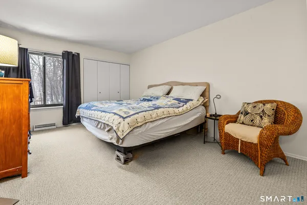 a spacious bedroom with a bed and a couch