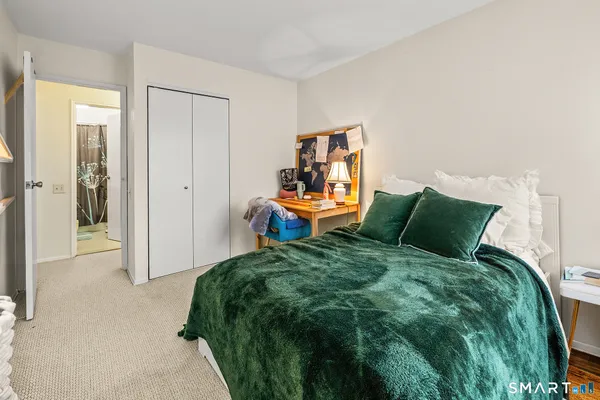 a large bed in a bedroom next to a small yard