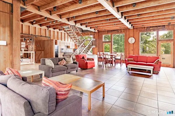 a living room with furniture a table and chairs