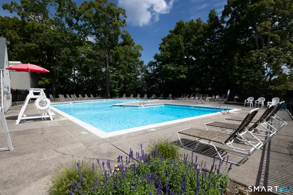 a view of a backyard with swimming pool