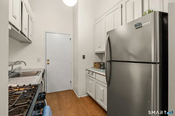 a kitchen with stainless steel appliances a refrigerator and a sink