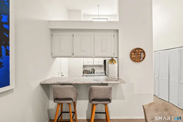 a table with a sink and a stove with wooden floor