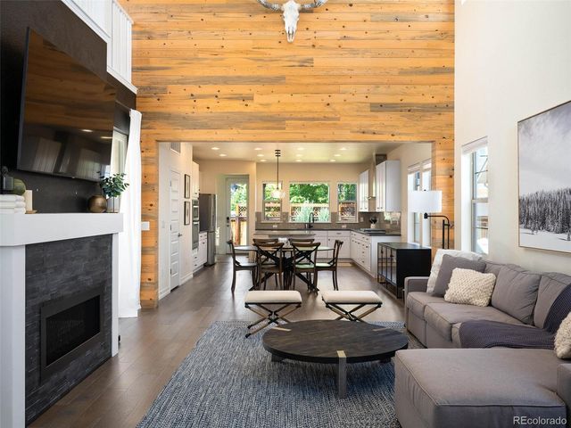 a living room with fireplace furniture and a fireplace