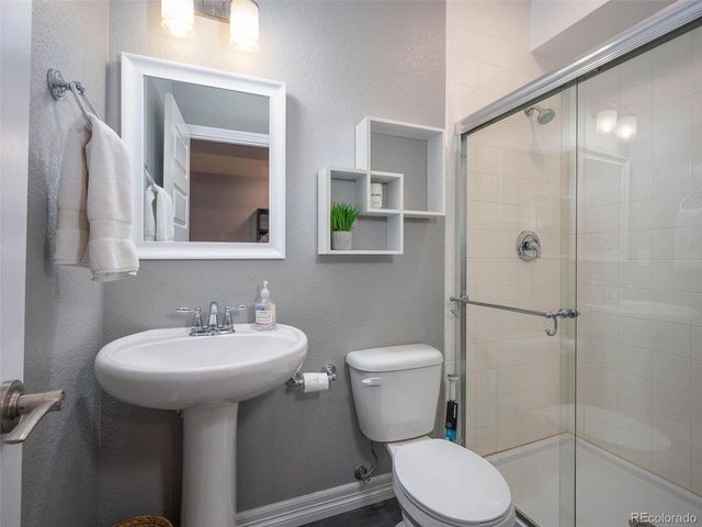 a bathroom with a sink toilet and shower