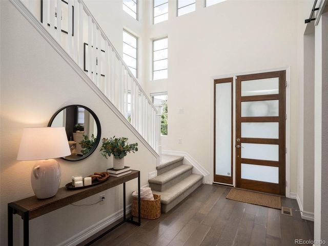 a view of entryway and hall with wooden floor