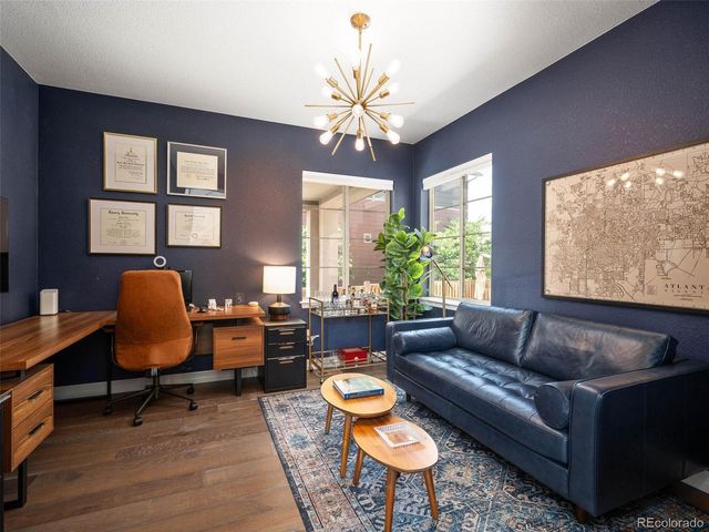 a living room with furniture a chandelier and a window