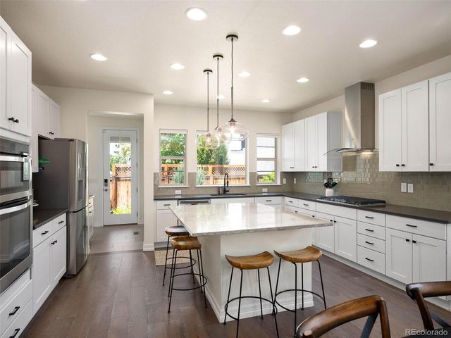 a large kitchen with granite countertop lots of counter space and window