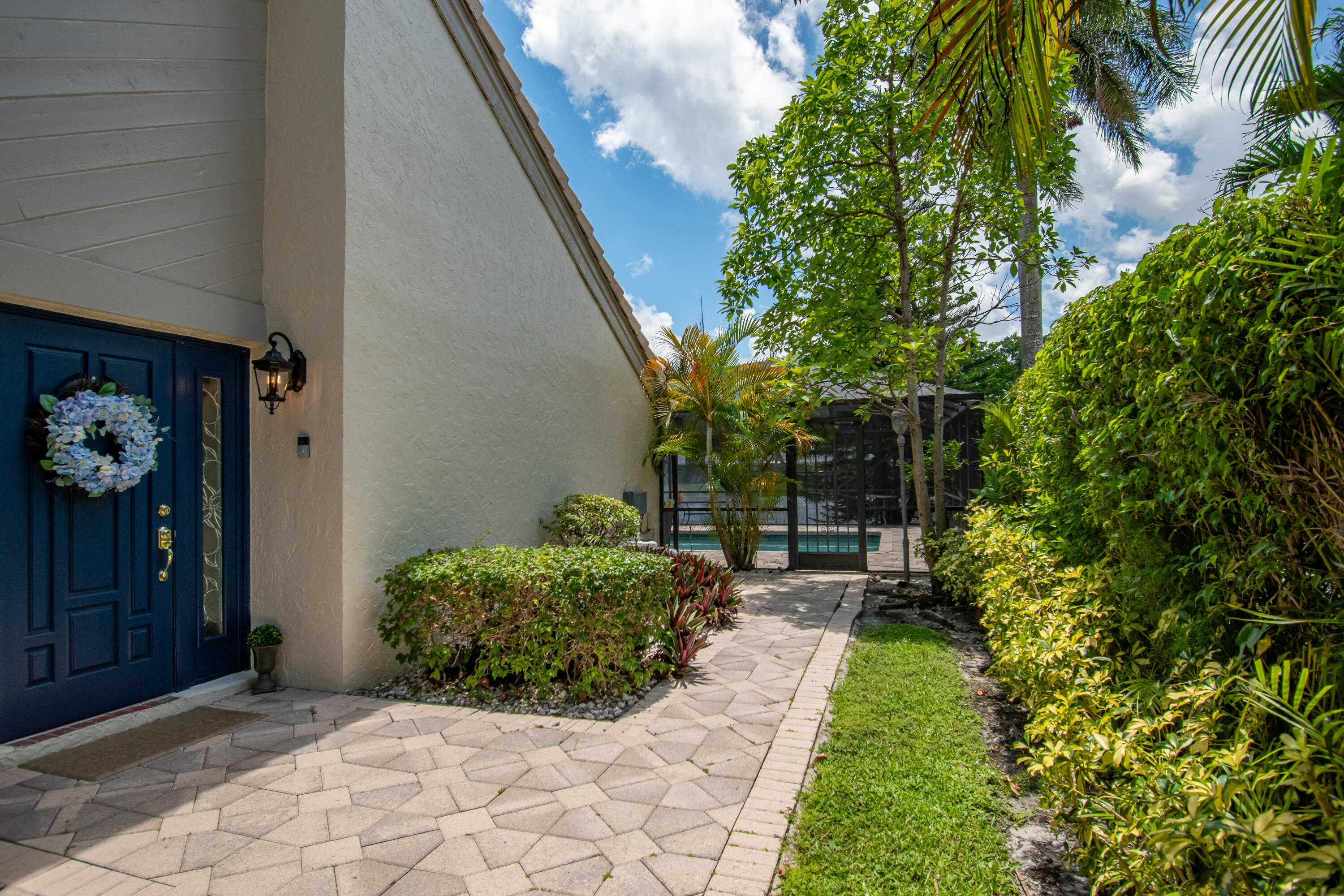 9708 Erica Court Boca Raton, FL 33496 - Photo 8 of 54 a view of a backyard with potted plants and large tree
