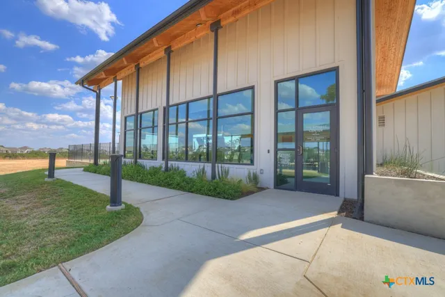 a view of a house with backyard and a tree