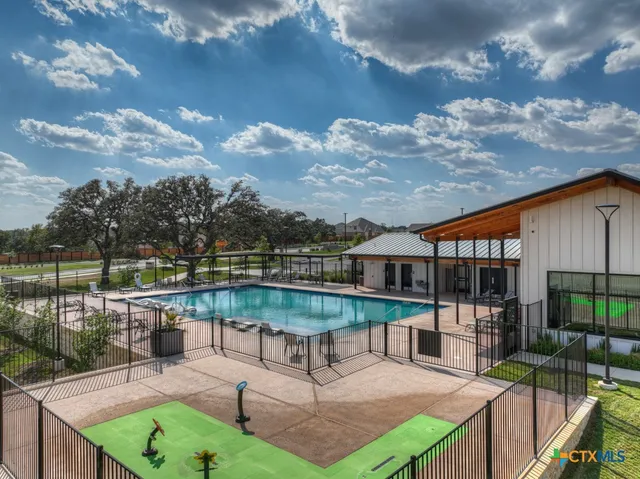 a view of a house with backyard outdoor seating and lake view