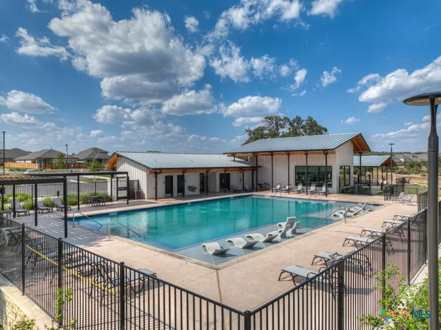 a view of a house with a backyard and a patio