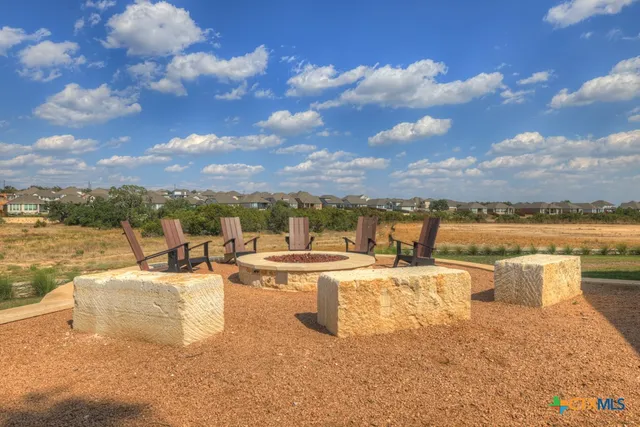 a view of a terrace with lawn chairs