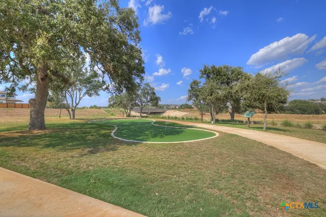 a view of a playground with green space
