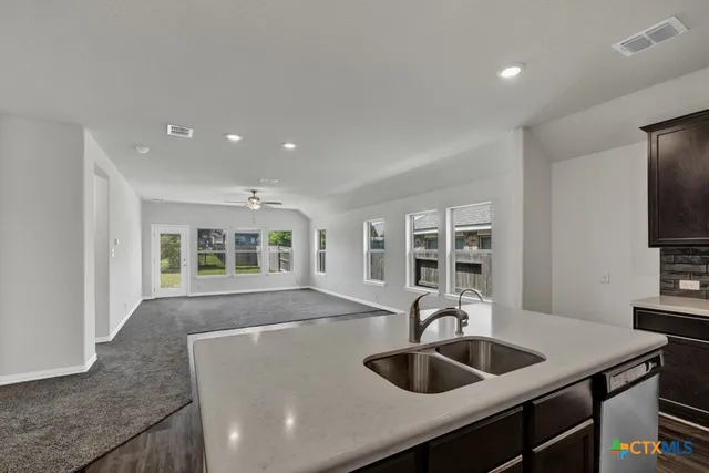 a kitchen with a sink and a refrigerator