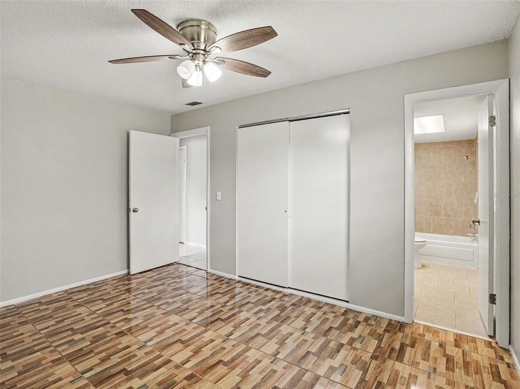 615 Thomas Jefferson Way Orlando, FL 32809 - Photo 14 of 17 a view of a bedroom with wooden floor