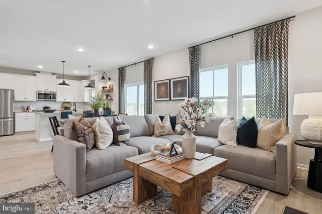 a living room with furniture kitchen and a table