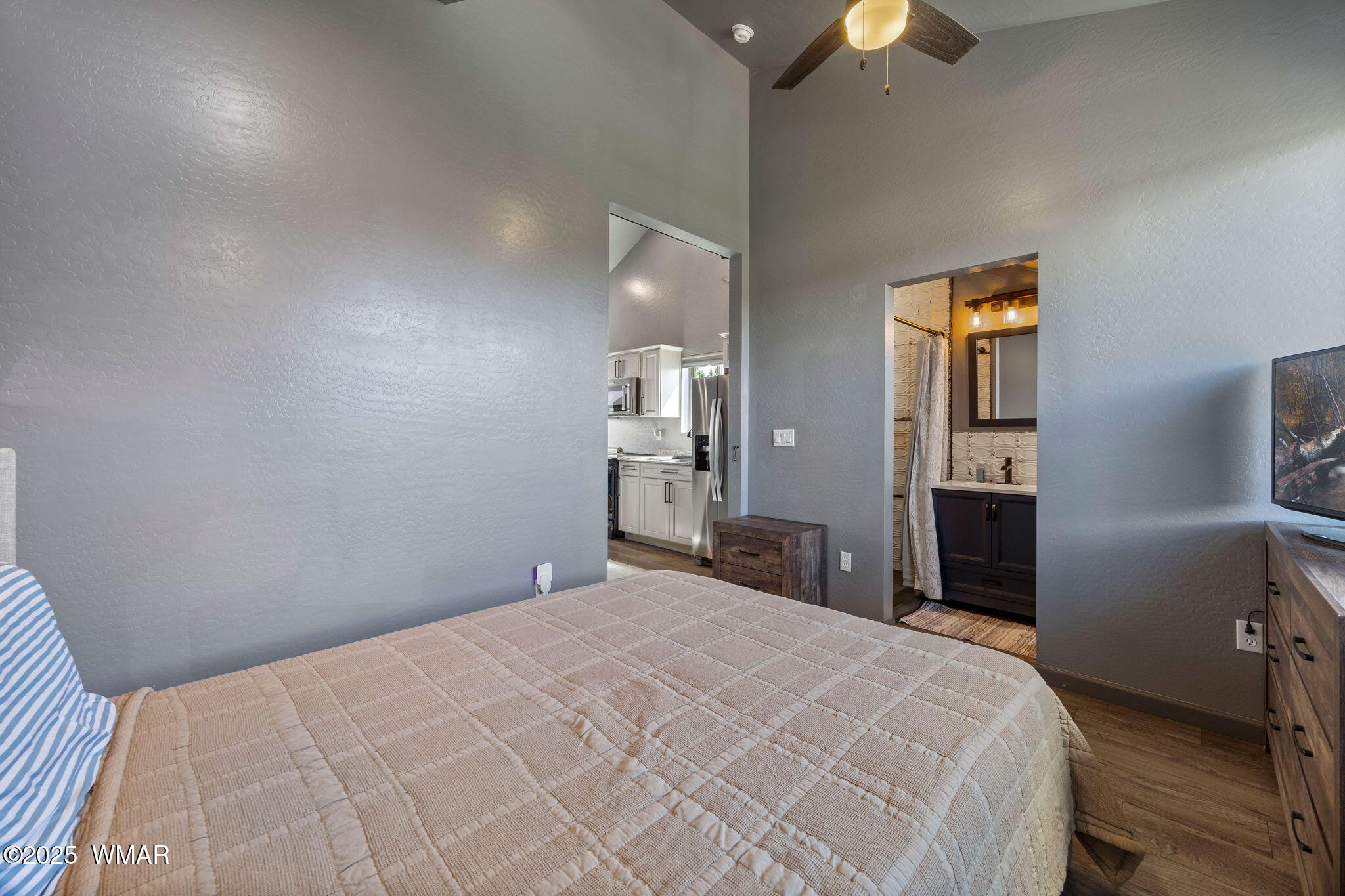 7106 Long Road Show Low, AZ 85901 - Photo 58 of 65 a bedroom with a bed and a chandelier