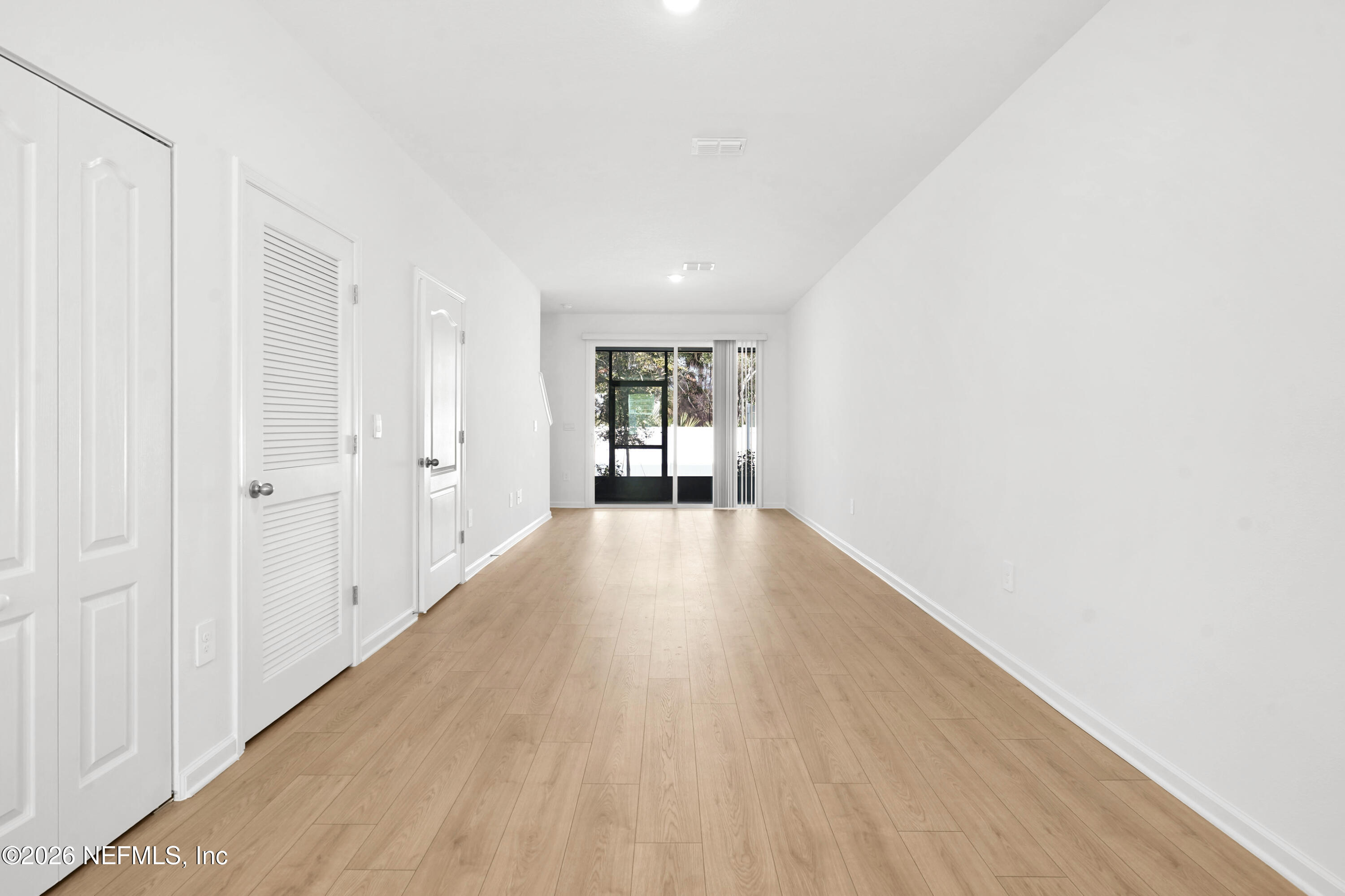 135 Palmetto Rdg Road St. Augustine, FL 32095 - Photo 4 of 27 a view of an empty room with wooden floor and a window