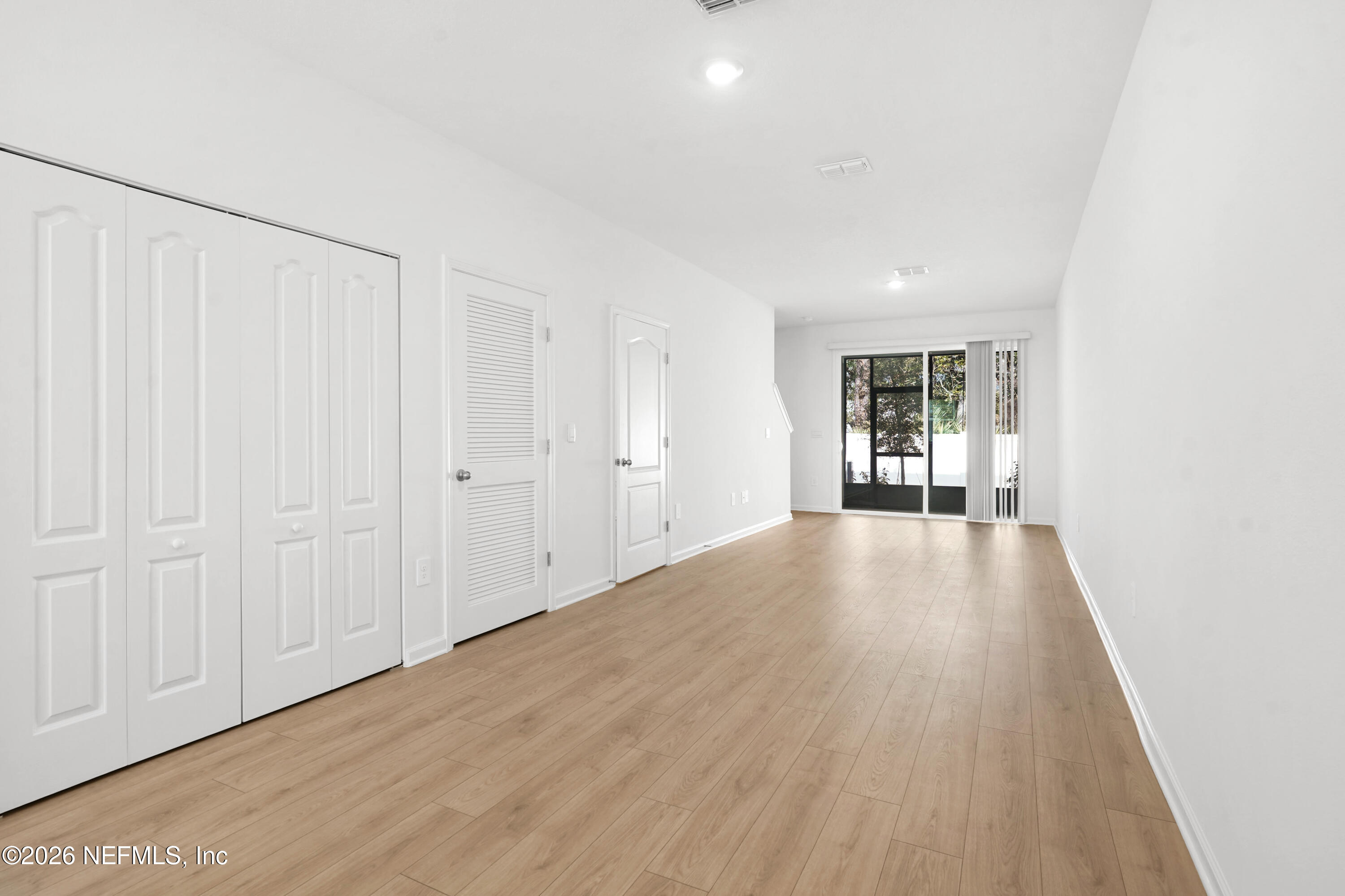 135 Palmetto Rdg Road St. Augustine, FL 32095 - Photo 5 of 27 a view of an empty room with wooden floor and a window
