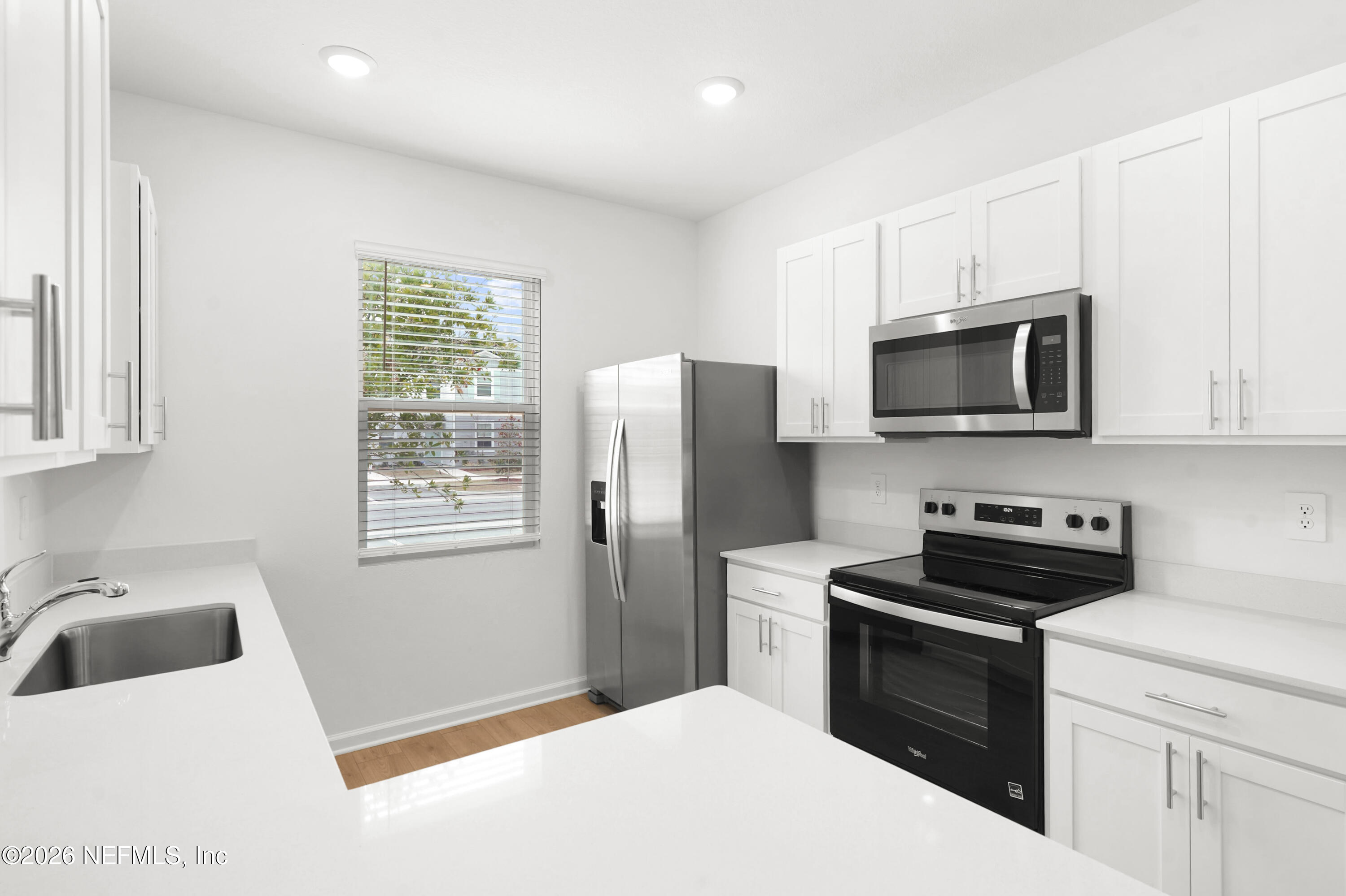 135 Palmetto Rdg Road St. Augustine, FL 32095 - Photo 7 of 27 a kitchen with a refrigerator stove and microwave