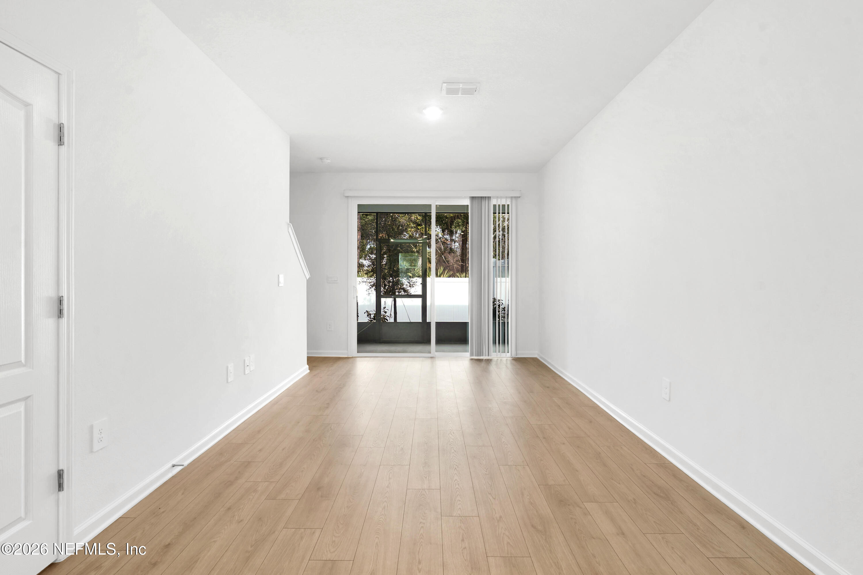 135 Palmetto Rdg Road St. Augustine, FL 32095 - Photo 10 of 27 an empty room with wooden floor and a window
