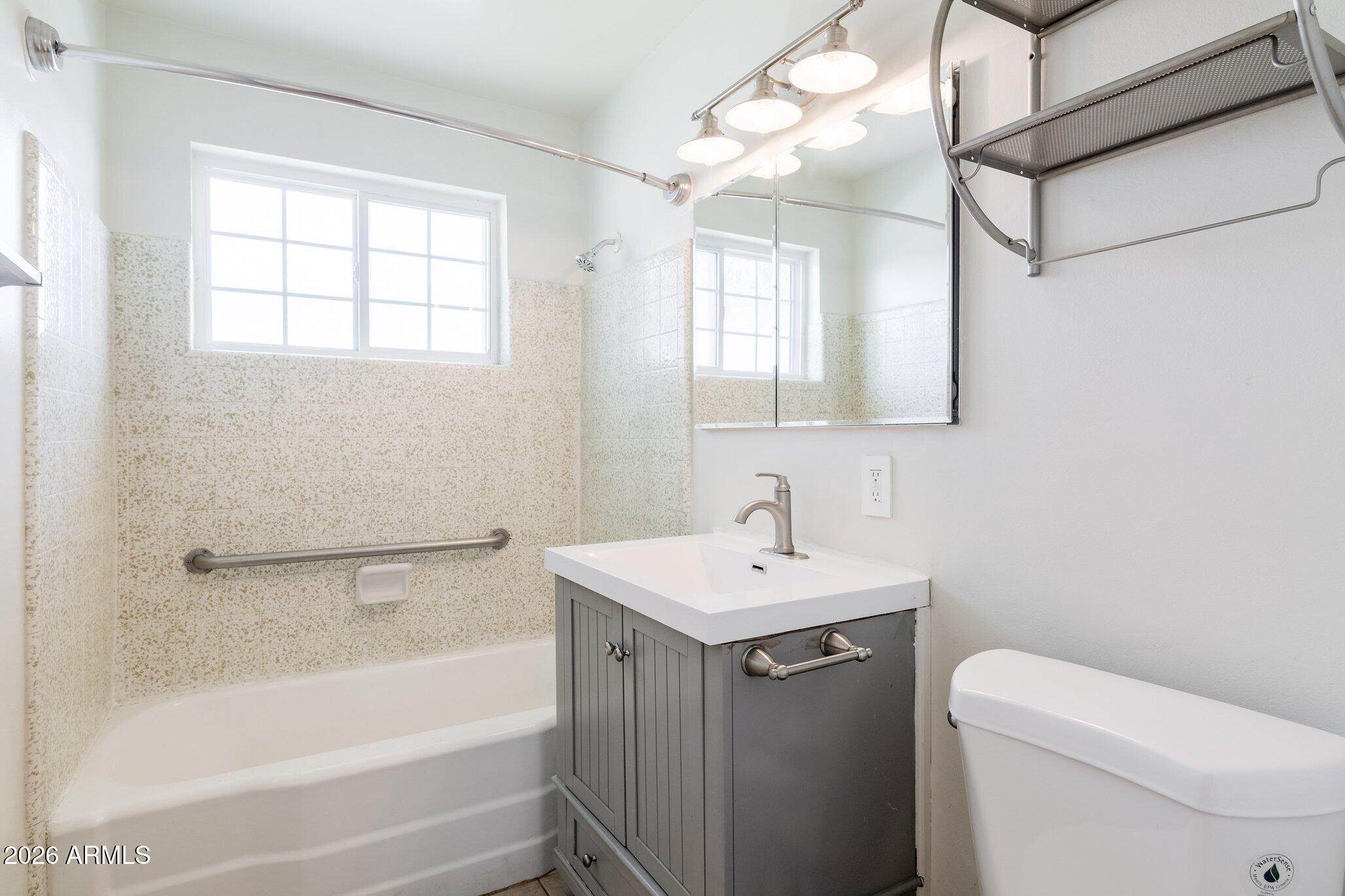 1335 East Broadway Road Mesa, AZ 85204 - Photo 14 of 23 a bathroom with a sink toilet and bathtub