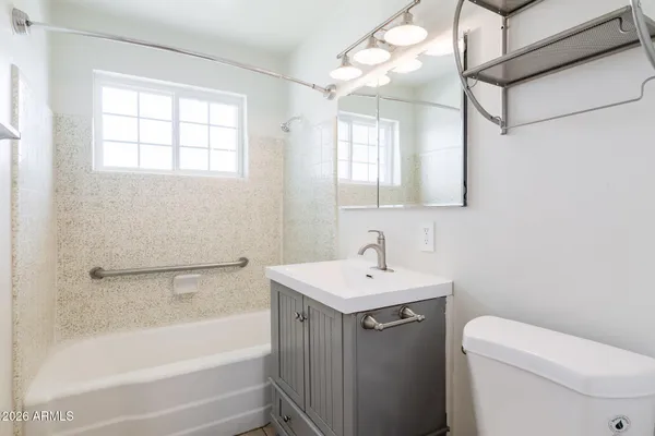 an empty room with a window and a ceiling fan