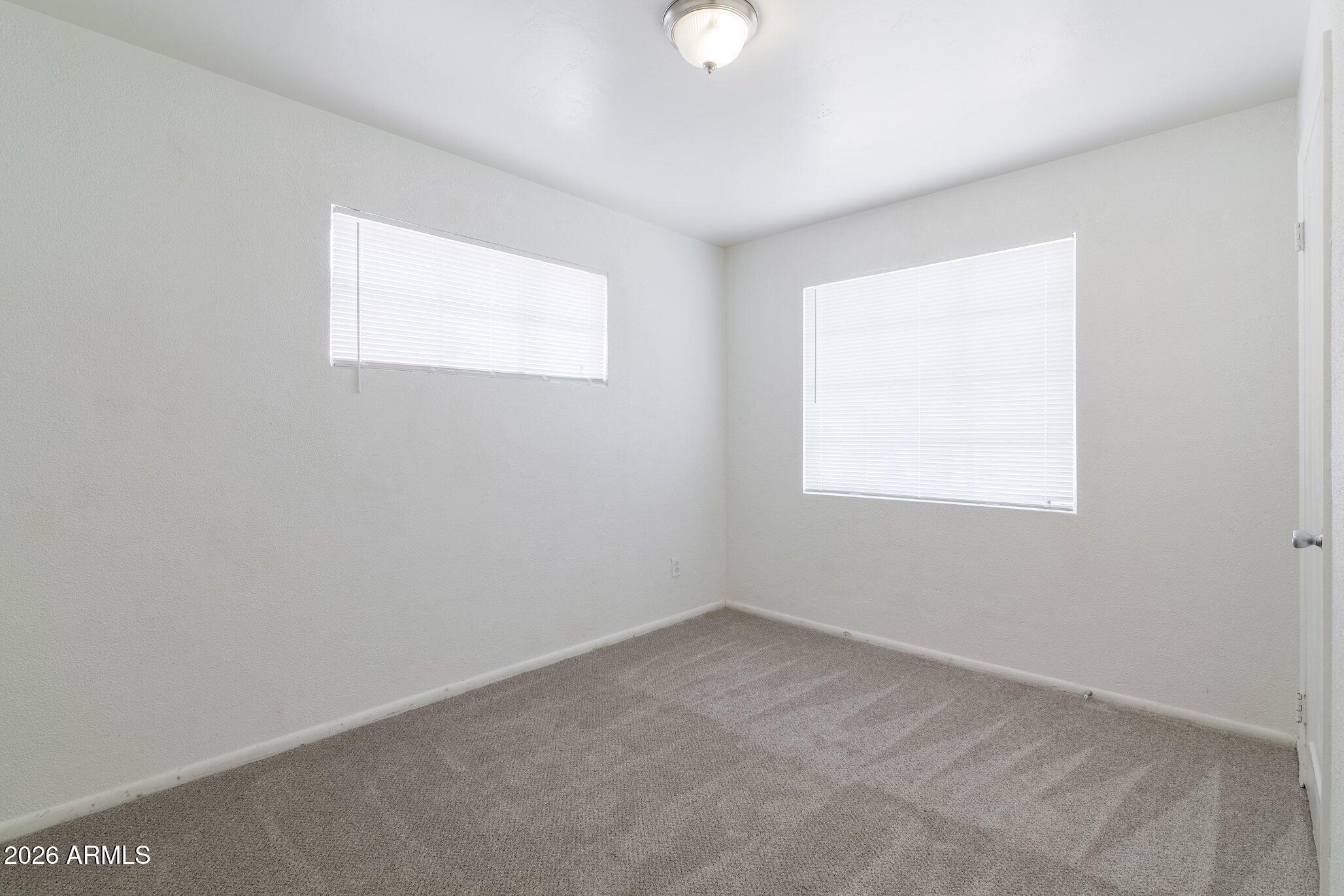 1335 East Broadway Road Mesa, AZ 85204 - Photo 18 of 23 an empty room with a window