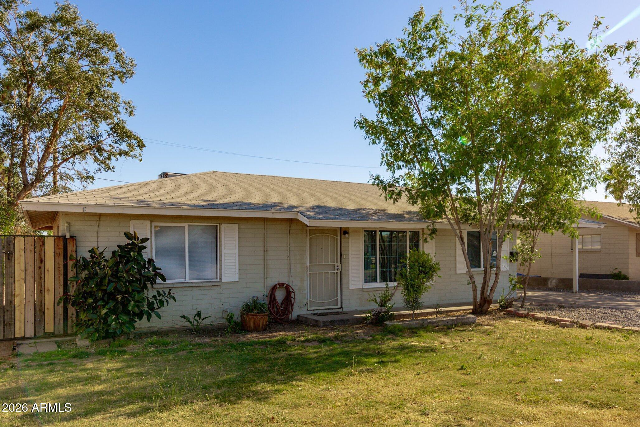 1335 East Broadway Road Mesa, AZ 85204 - Photo 2 of 23 a backyard of a house with yard table and chairs