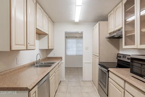 a kitchen that has a sink and a stove