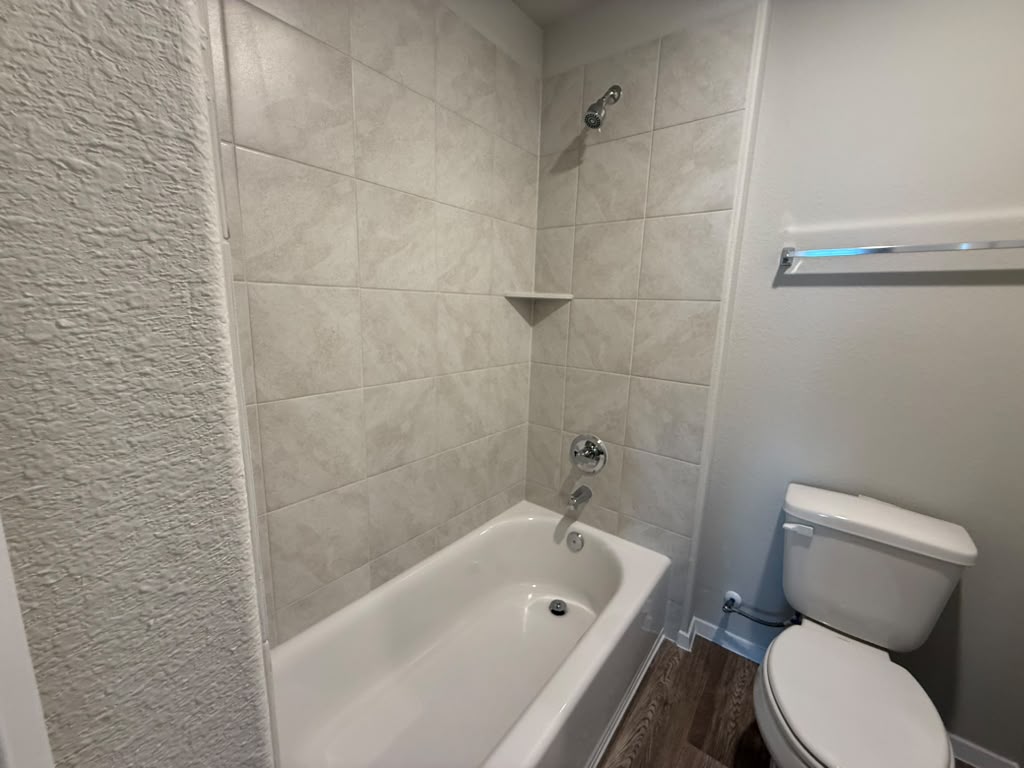 2601 Foss Road Manor, TX 78653 - Photo 32 of 40 A classic bathtub and shower combination is surrounded by neutral tile surround.