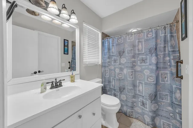 a bathroom with a sink toilet a mirror and shower