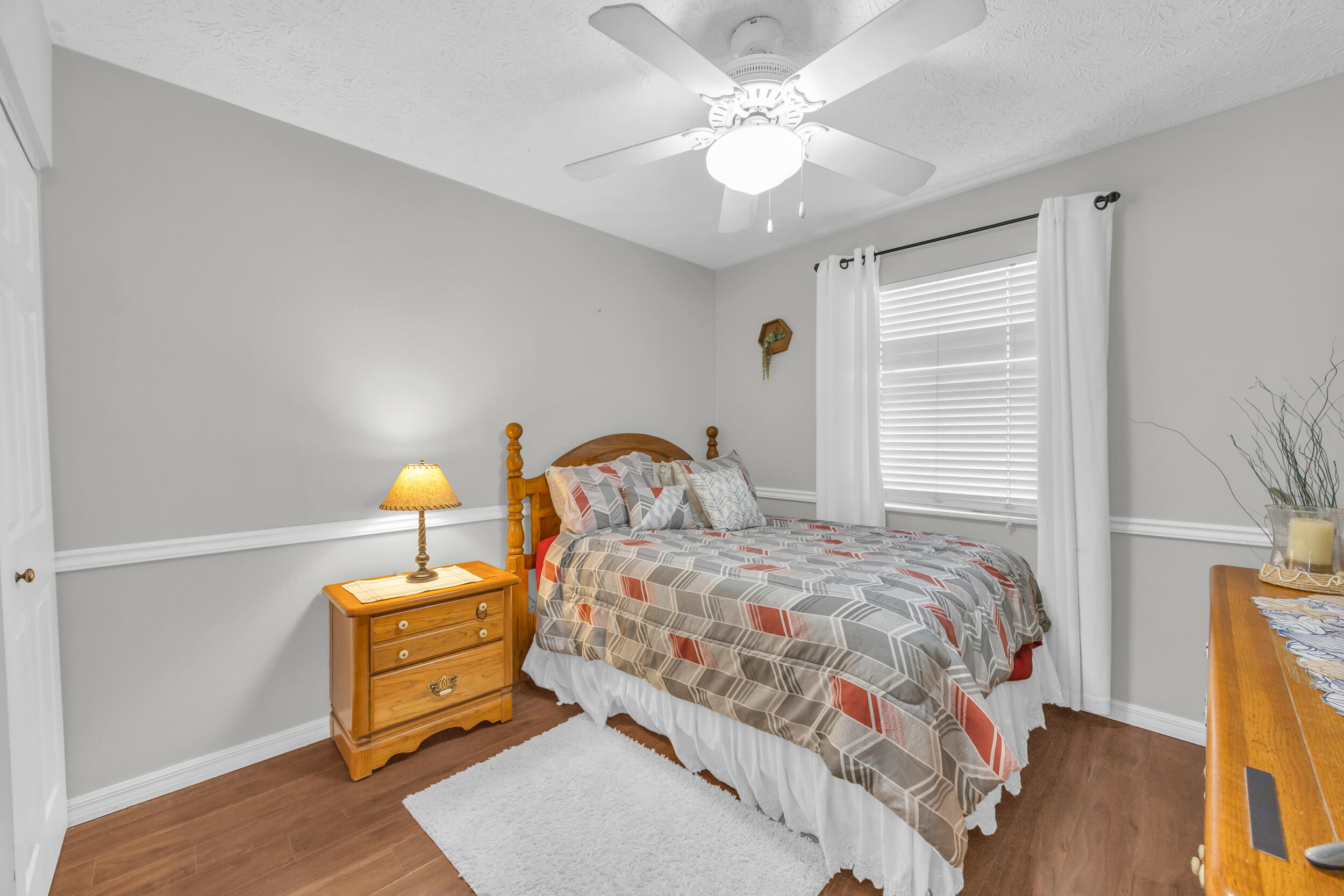 261 Southwest Chelsea Terrace Port St. Lucie, FL 34984 - Photo 17 of 25 a bedroom with a bed and wooden floor