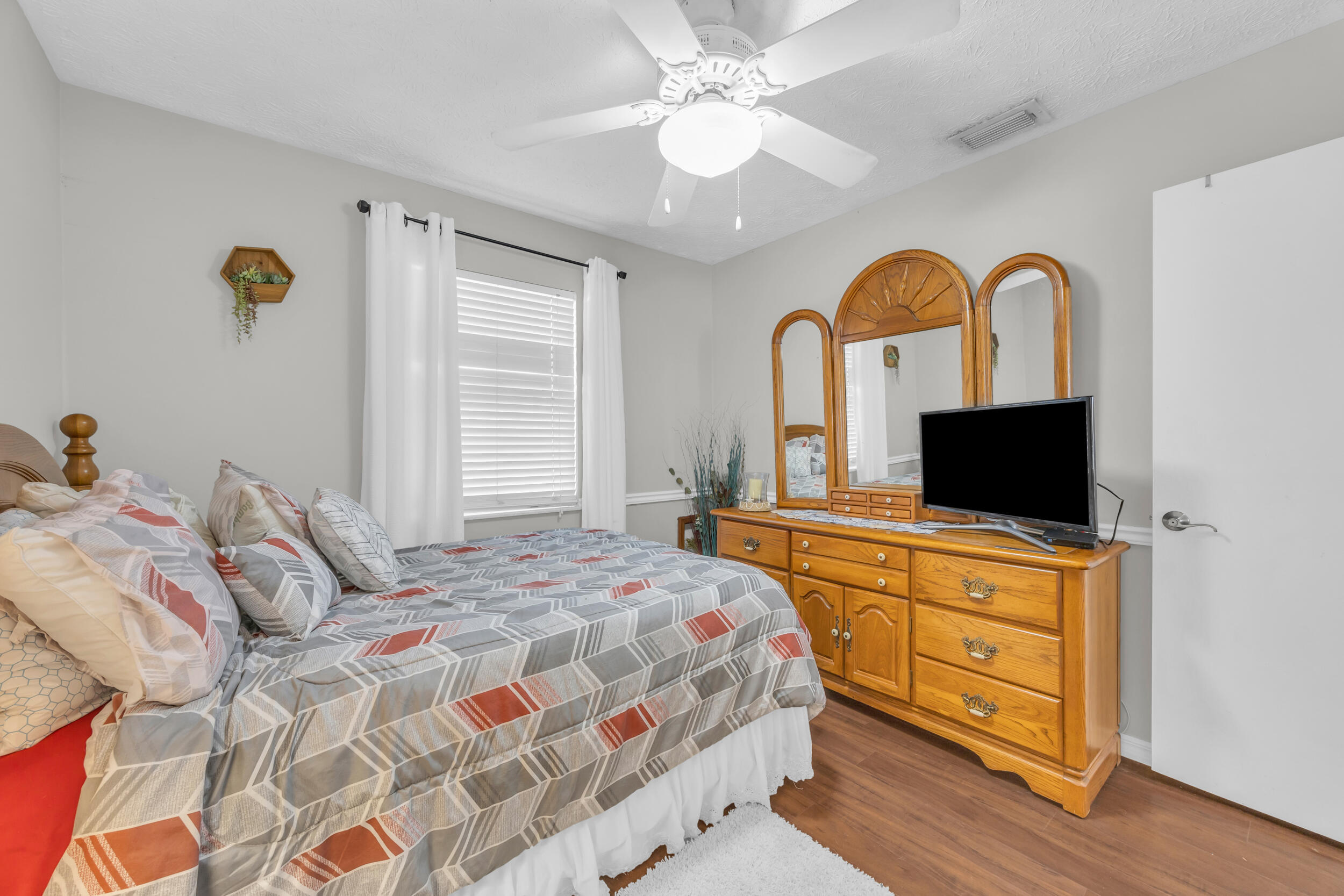 261 Southwest Chelsea Terrace Port St. Lucie, FL 34984 - Photo 18 of 25 a bedroom with a bed and a flat screen tv