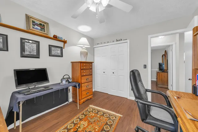 a view of a workspace with furniture and a flat screen tv
