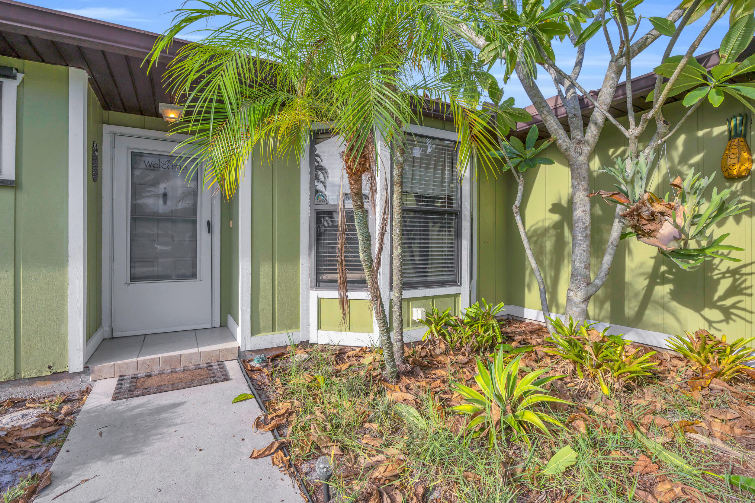 261 Southwest Chelsea Terrace Port St. Lucie, FL 34984 - Photo 2 of 25 a front view of a house with a garden