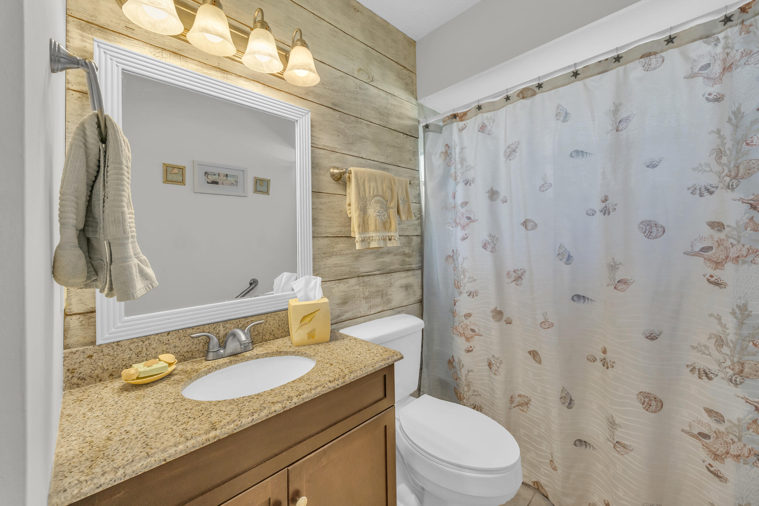 261 Southwest Chelsea Terrace Port St. Lucie, FL 34984 - Photo 21 of 25 a bathroom with a granite countertop sink a toilet and a mirror