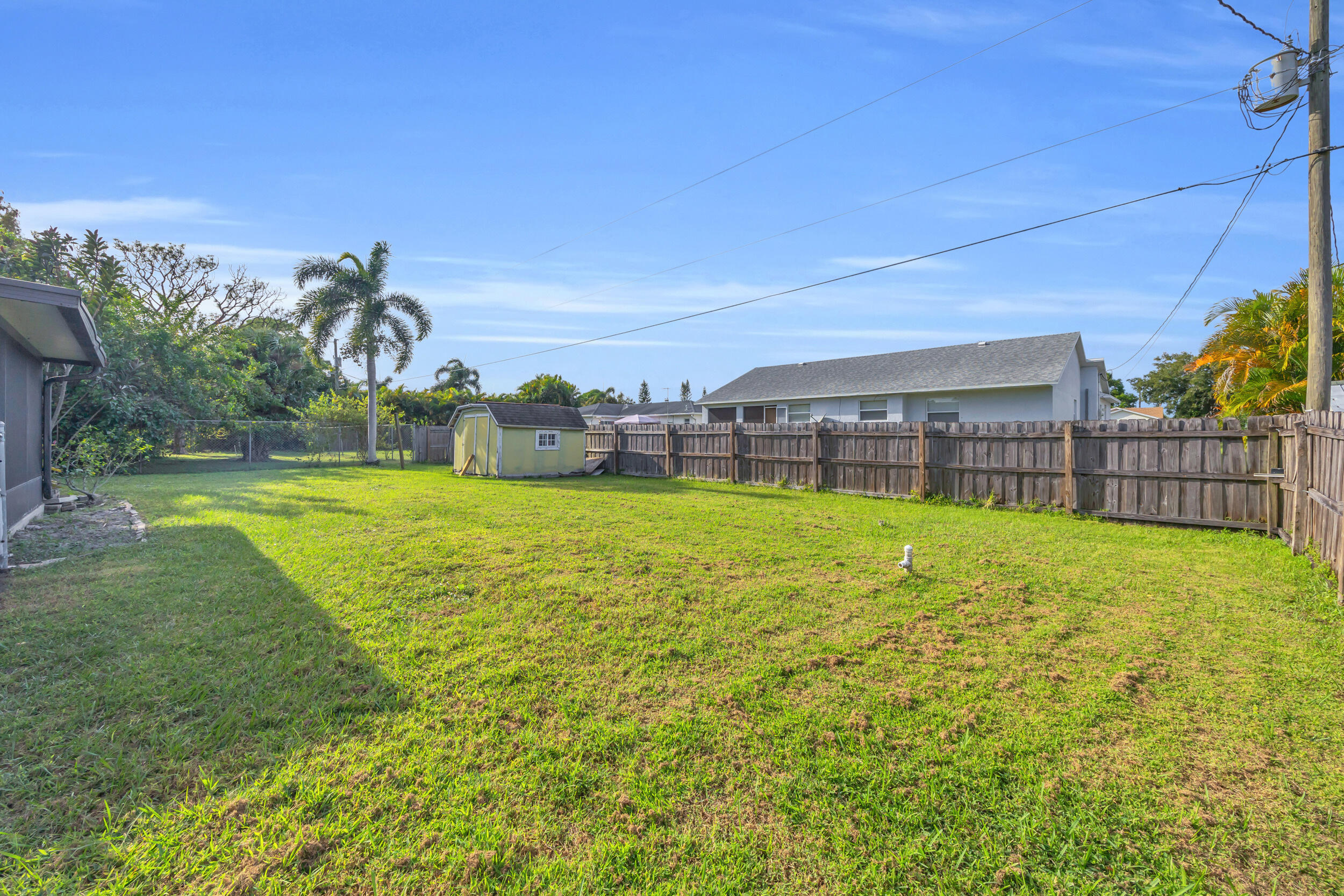 261 Southwest Chelsea Terrace Port St. Lucie, FL 34984 - Photo 24 of 25 a swimming pool with outdoor seating and yard