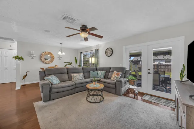 a living room with furniture and a clock