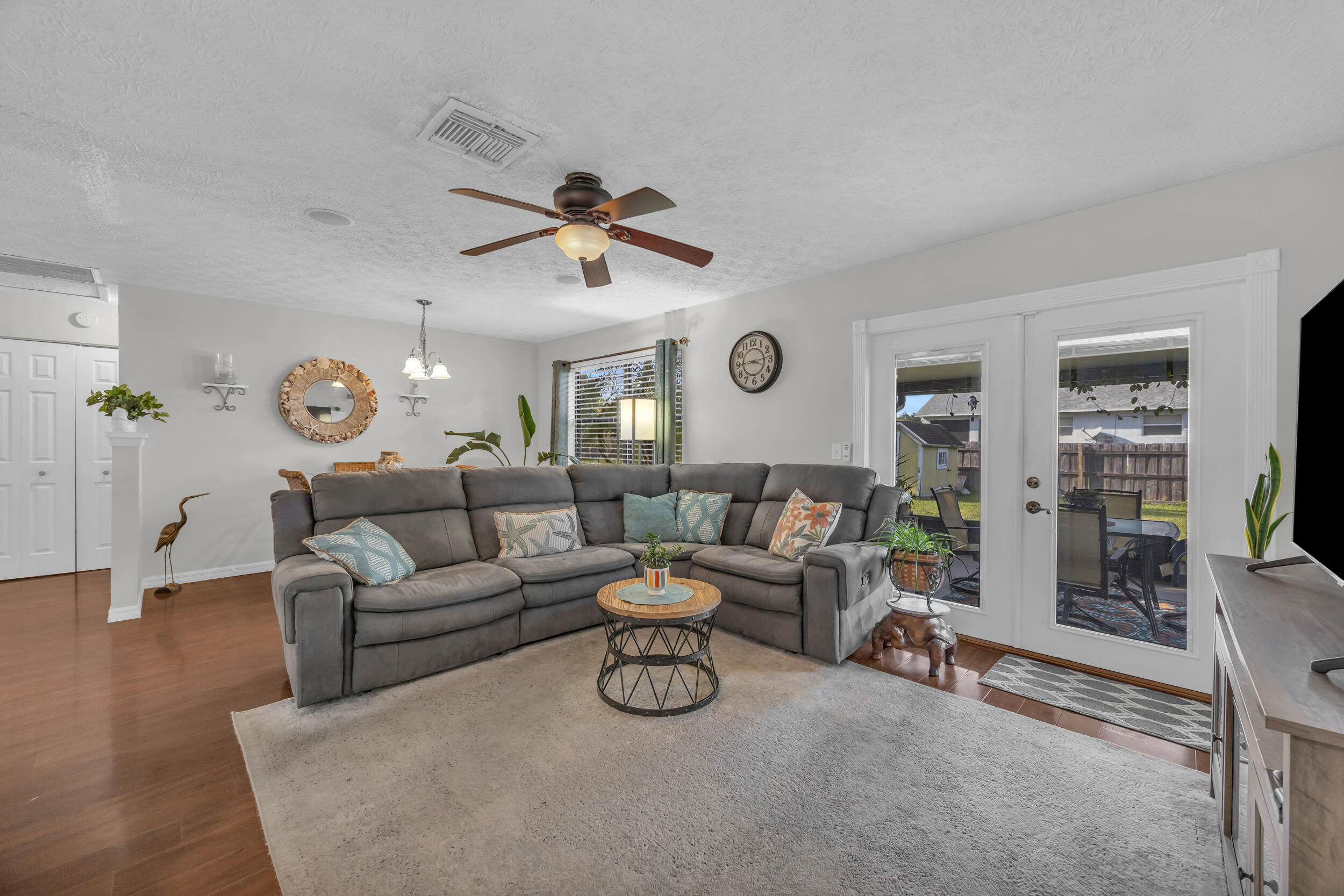 261 Southwest Chelsea Terrace Port St. Lucie, FL 34984 - Photo 7 of 25 a living room with furniture and a clock