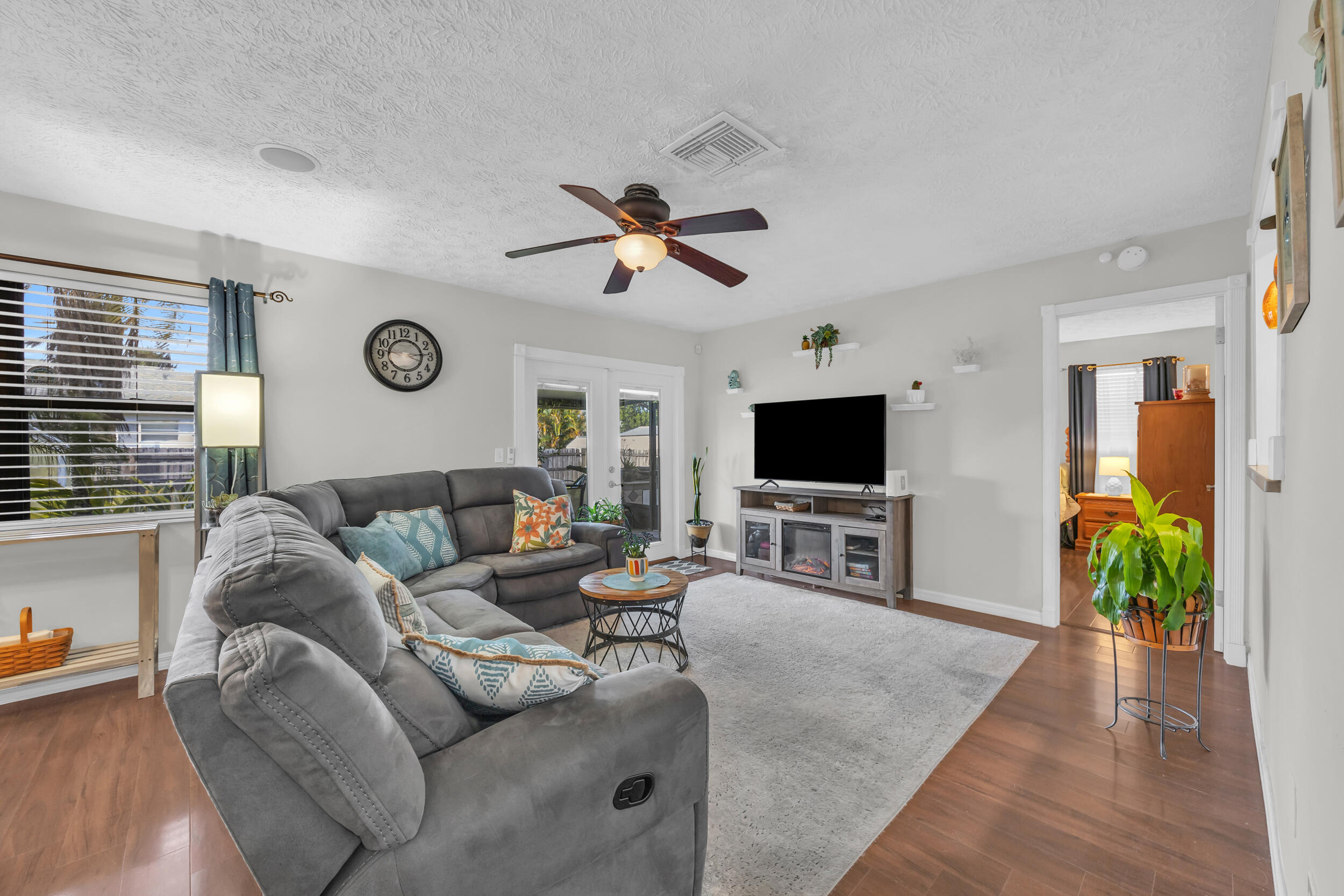 261 Southwest Chelsea Terrace Port St. Lucie, FL 34984 - Photo 8 of 25 a living room with furniture and a flat screen tv