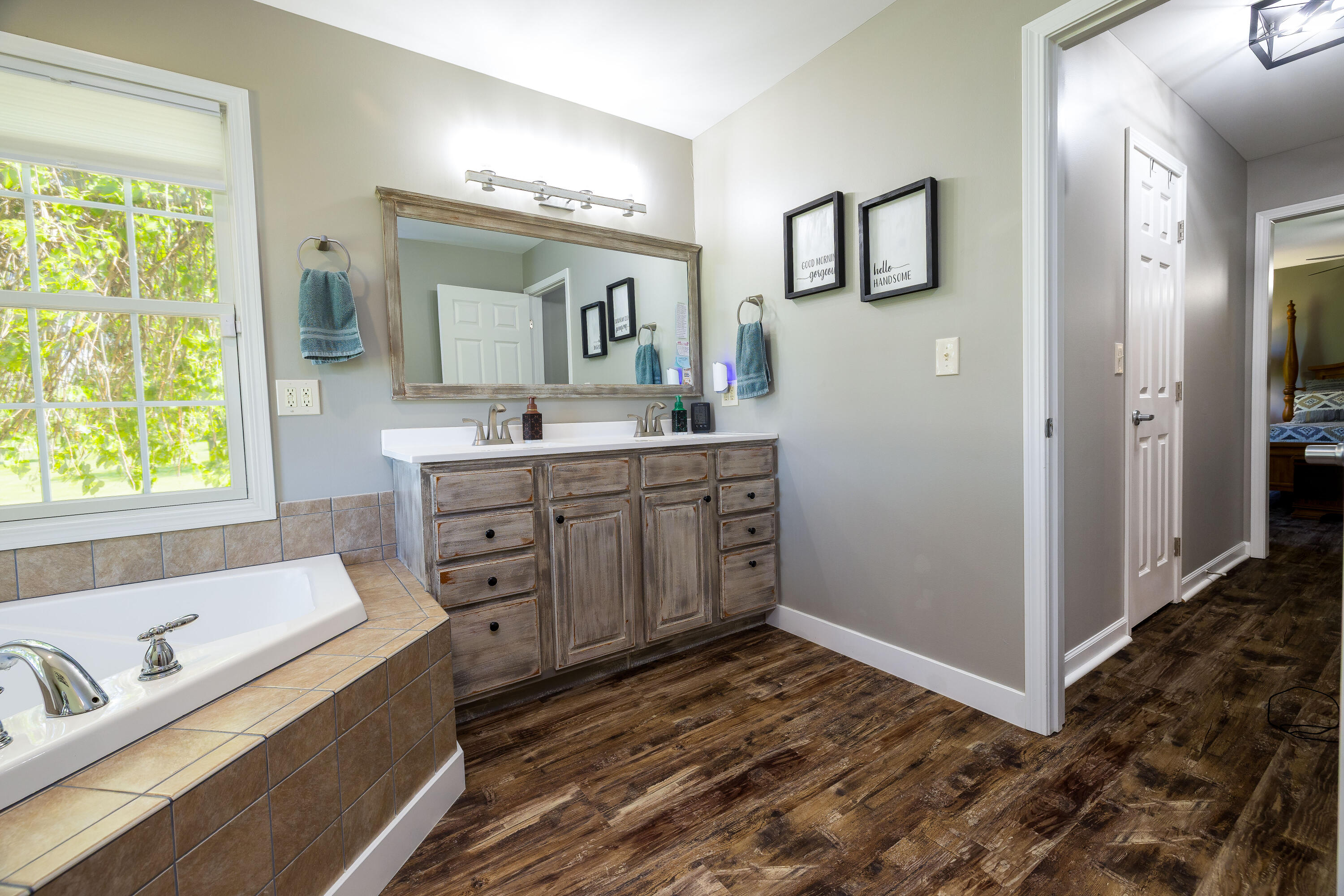 1601 East Amsler Road Rensselaer, IN 47978 - Photo 36 of 70 a spacious bathroom with a granite countertop sink mirror and a bathtub