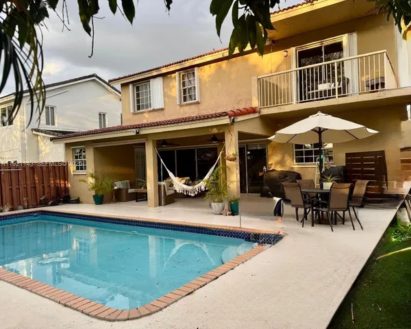 a view of a house with pool porch and sitting area